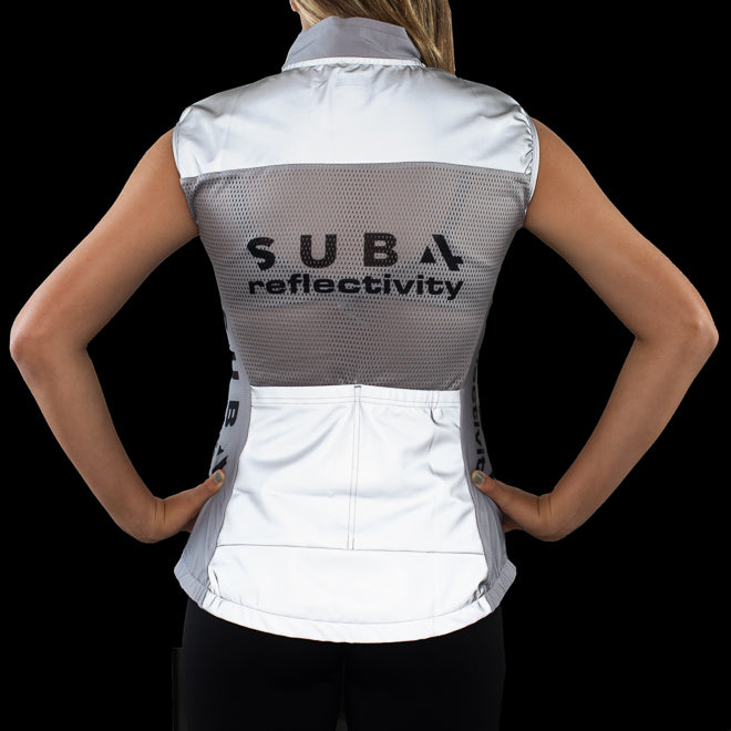 Person wearing a white vest with 'Sub4' Reflectivity' branding on a black background