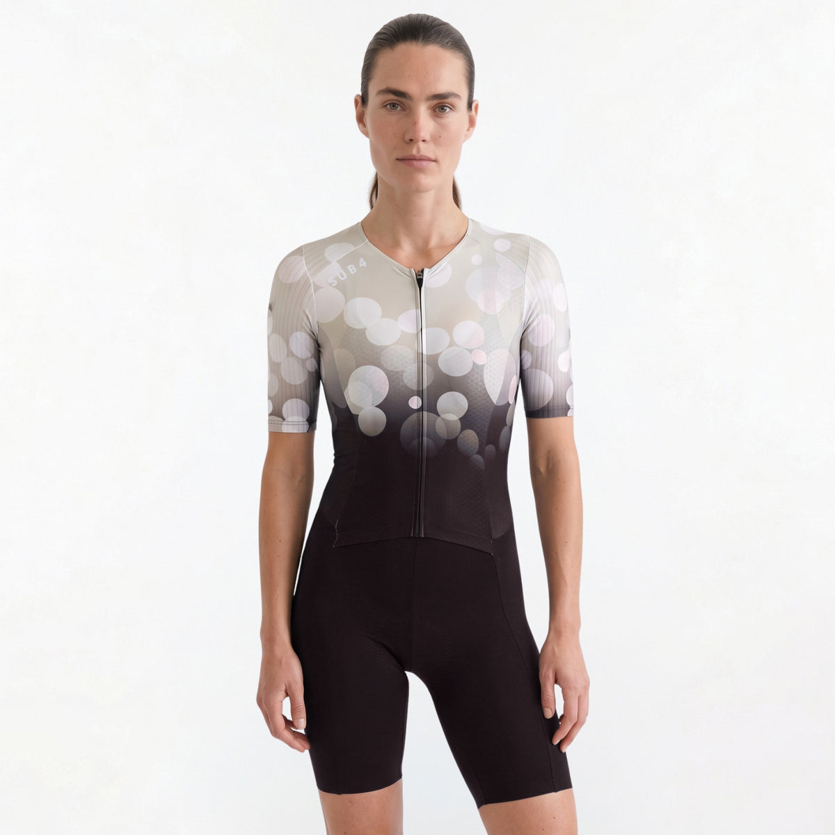 Woman wearing a Triathlon suit with a white and black gradient design on a plain background