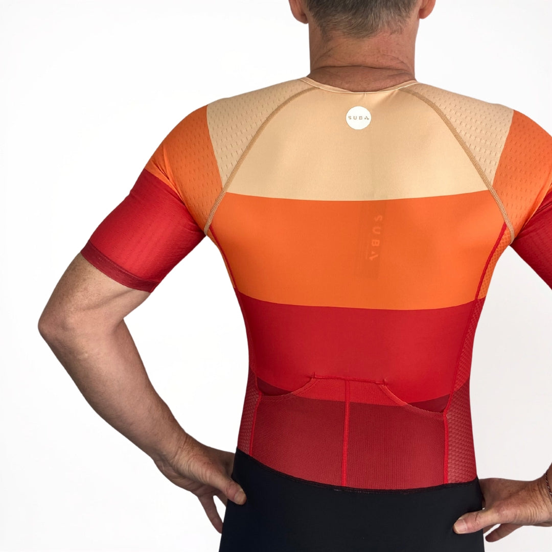 Person wearing a red and orange Tri Suit on a white background