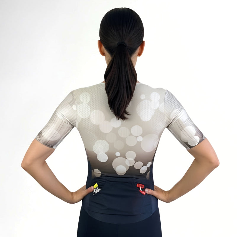 Person wearing a white and black Tri suit with a white background