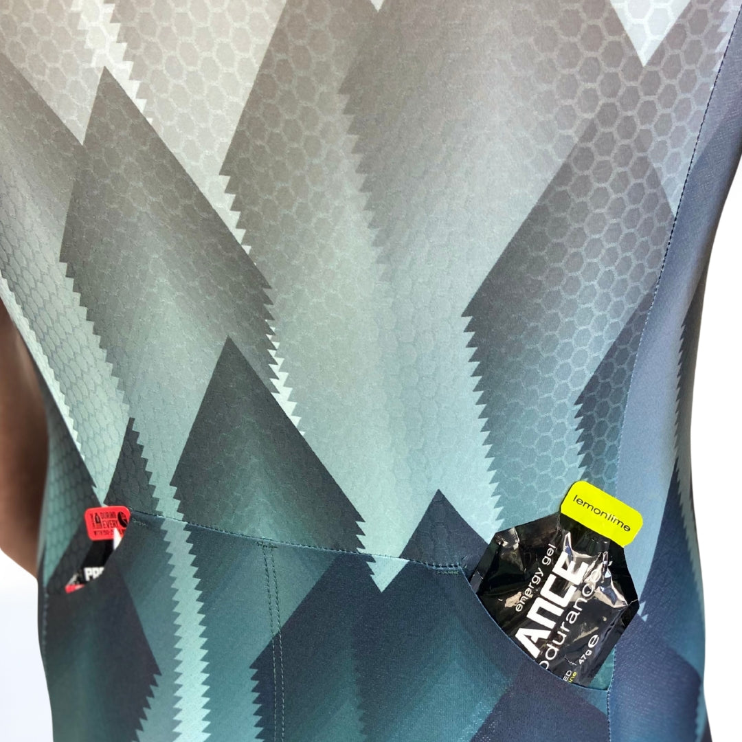 Close-up of a tri suit back pockets with brand labels on a geometric patterned background