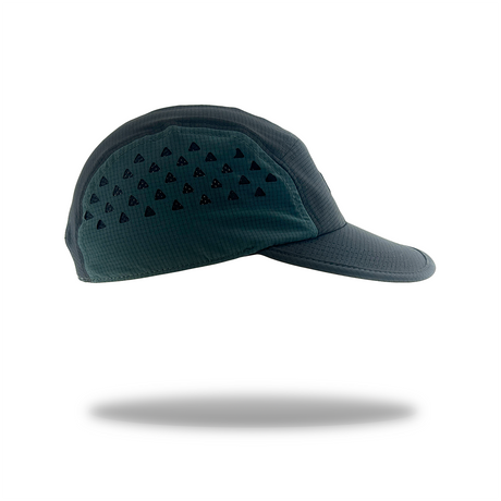 A dark teal athletic cap with a curved brim, featuring a pattern of small black triangles on the front panel, shown against a plain white background with a soft shadow underneath.