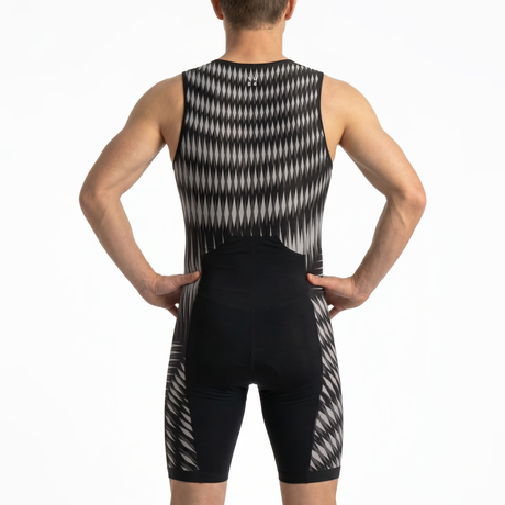 Rear view of a man wearing a sleeveless athletic tri-suit with a black and white geometric pattern, set against a plain white background.