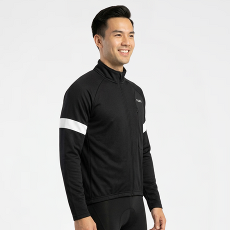 Person wearing black cycling jersey and shorts with white reflective accents on a light gray background