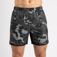 Camouflage shorts worn by a person on a white background