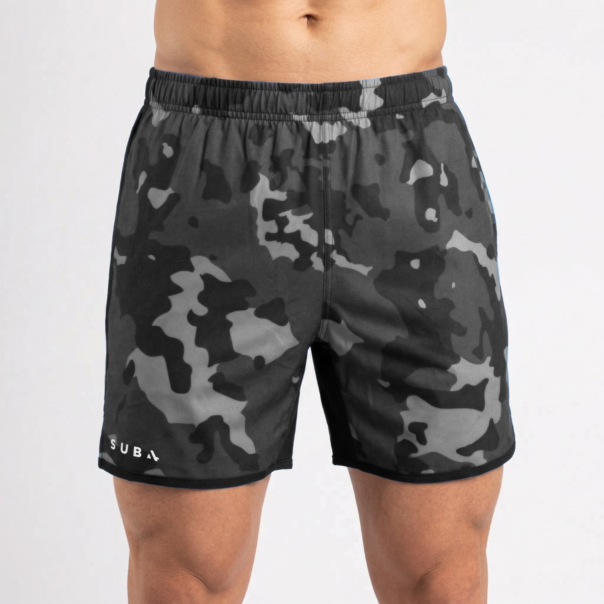 Camouflage shorts worn by a person on a white background