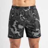 Camouflage shorts worn by a person on a white background