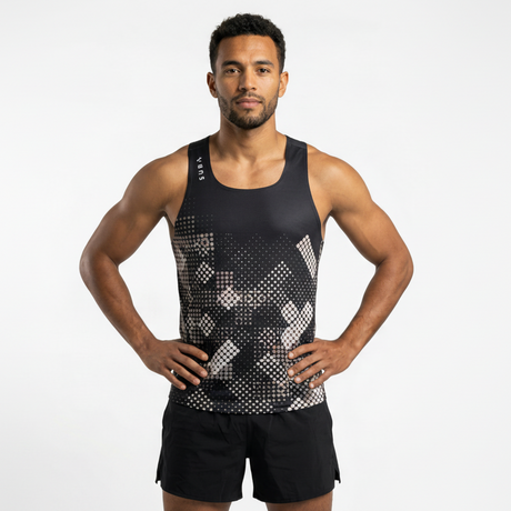 Man wearing a black athletic tank top with geometric pattern on a white background