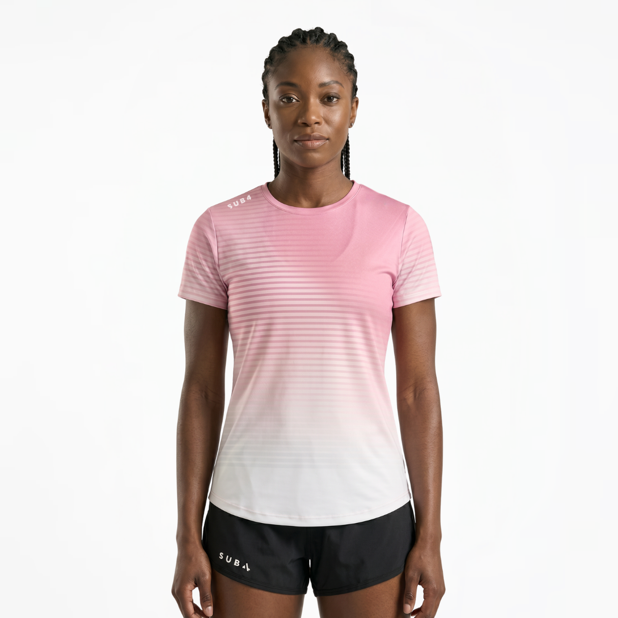 Woman wearing a pink and white gradient running t-shirt and black running shorts on a white background