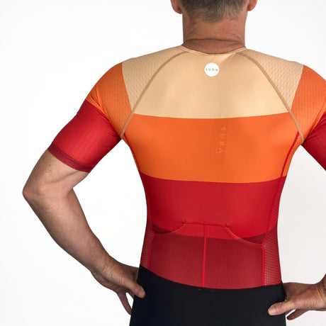 Person wearing a red and orange Tri Suit on a white background
