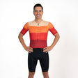Man wearing a colourful triathlon outfit on a white background