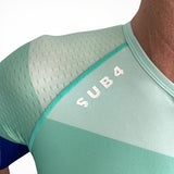 Close-up of a green Triathlon top with 'SUB4' branding on a white background