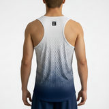 Person wearing a white and blue dot geometric gradient tank top on a plain background