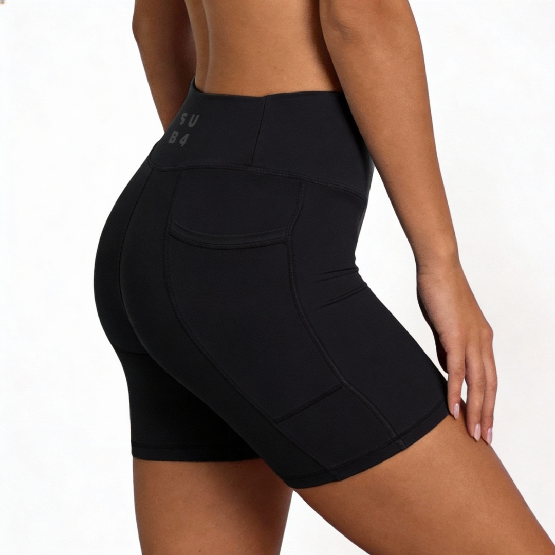 Black athletic shorts worn by a person on a white background