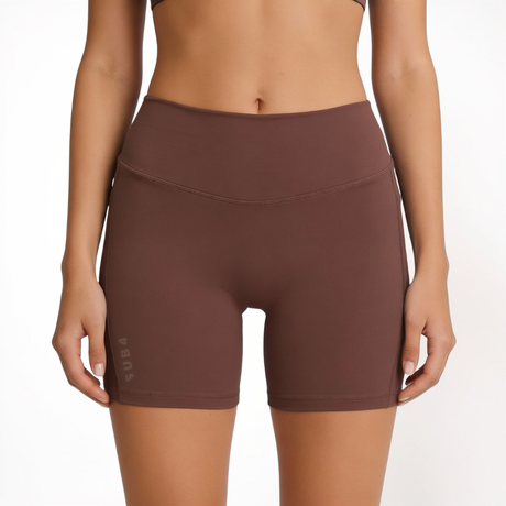 Brown athletic shorts worn by a person on a white background