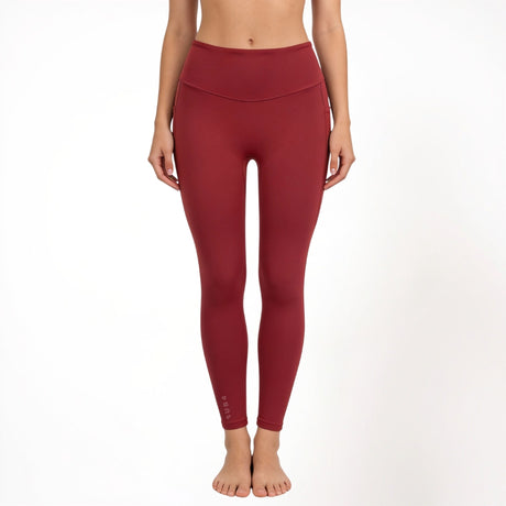 Red athletic yoga gym leggings worn by a person on a white background