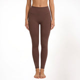 Brown athletic yoga leggings worn by a person on a white background