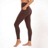 Brown athletic yoga gym leggings worn by a person on a white background