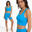 Woman wearing a blue athletic outfit with 'SUB4' branding on a white background