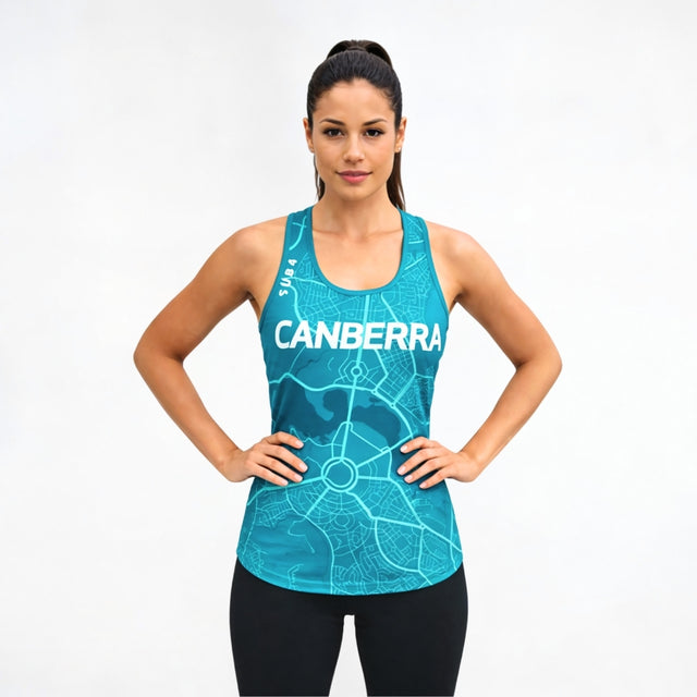 Woman wearing a blue tank top singlet with 'Canberra' printed on it against a white background