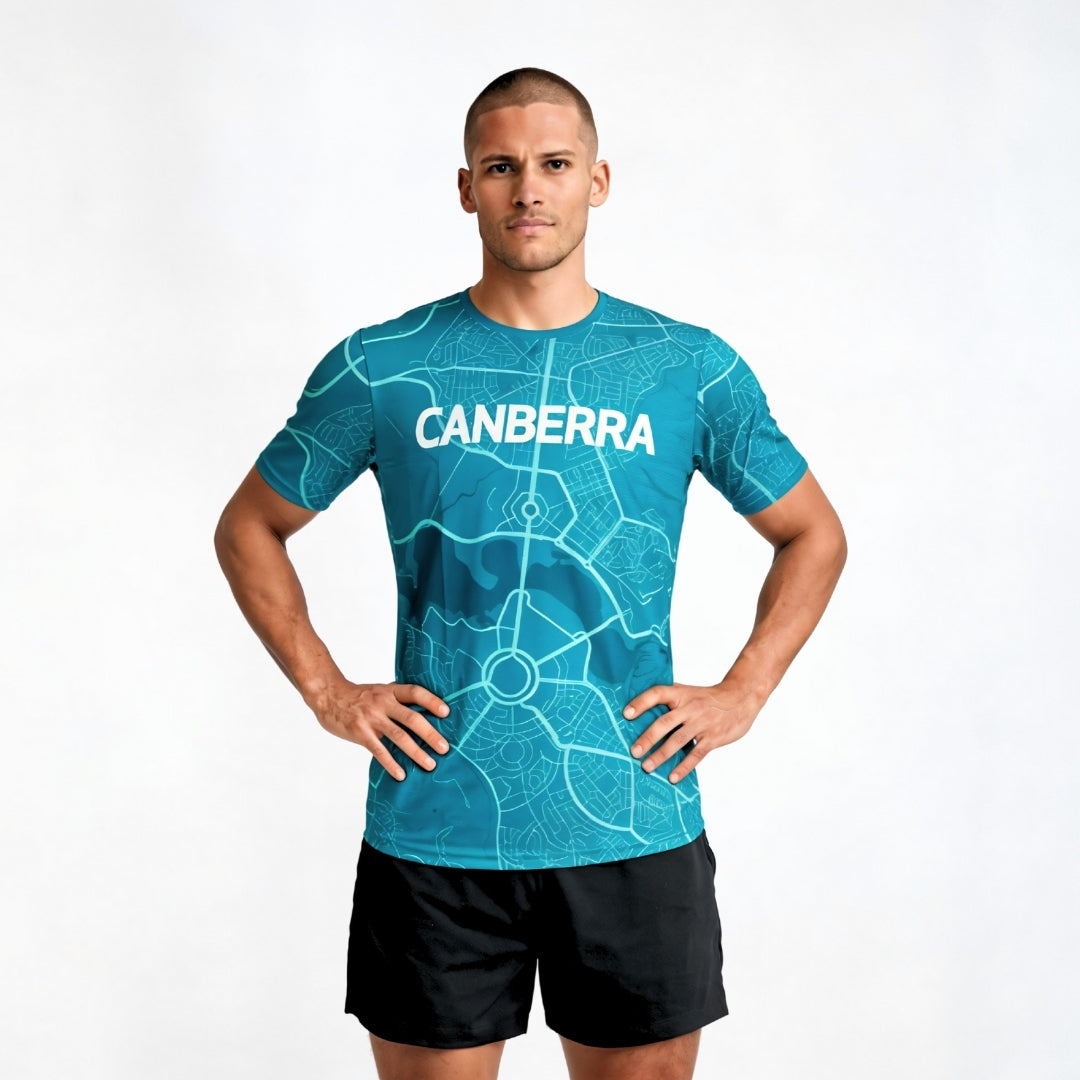 Man wearing a blue t-shirt with 'Canberra' printed on it against a white background