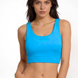 Woman wearing a blue sports bra with 'SUB4' branding on a white background