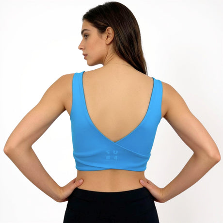 Woman wearing a blue sports bra on a white background
