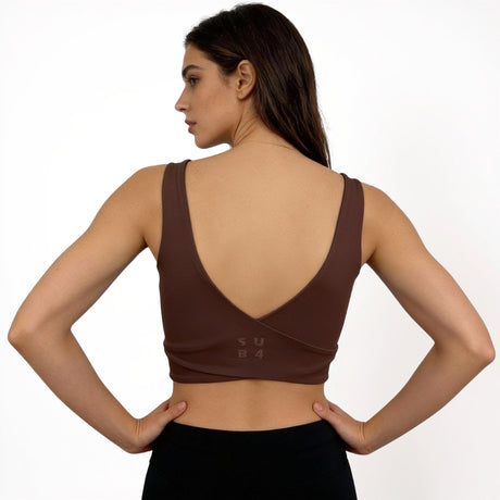 Woman wearing a brown sports bra with 'SUB4' branding on a white background