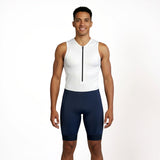 Man wearing a white sleeveless Triathlon suit with navy shorts on a white background