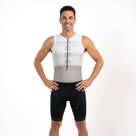 Man wearing a white sleeveless Triathlon outfit with black shorts on a white background