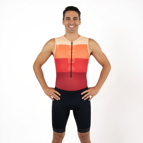 Man wearing a red, orange, and black triathlon suit on a white background