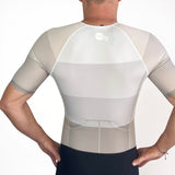 Person wearing a white Triathlon suit with mesh panels on a plain background