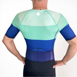 Person wearing a blue and green Triathlon suit on a white background